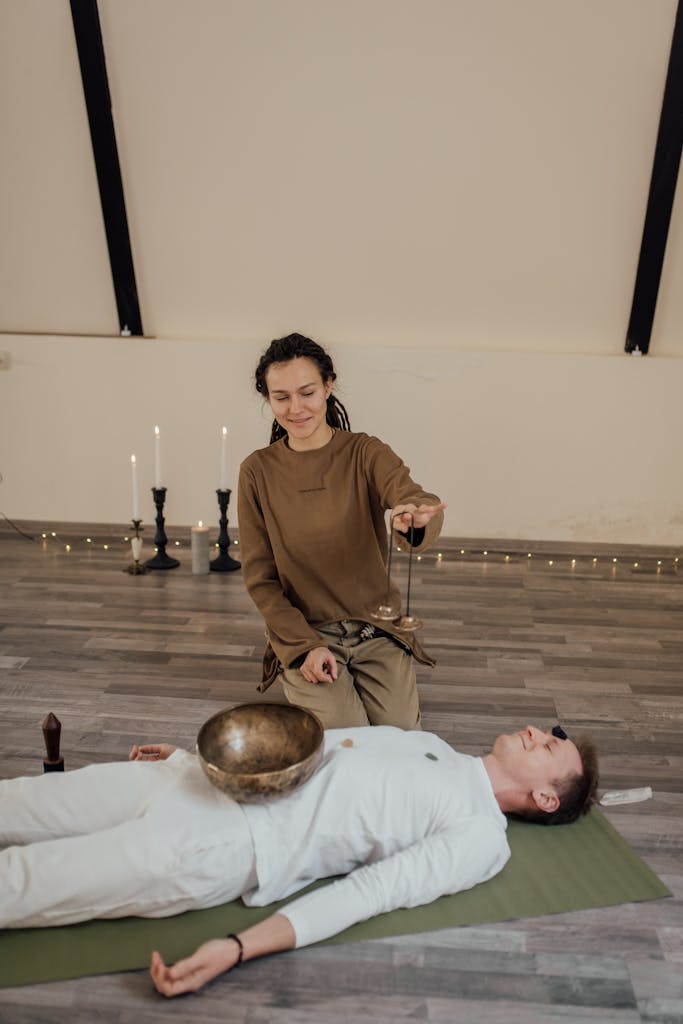A serene alternative healing session using a singing bowl indoors, promoting relaxation and meditation.