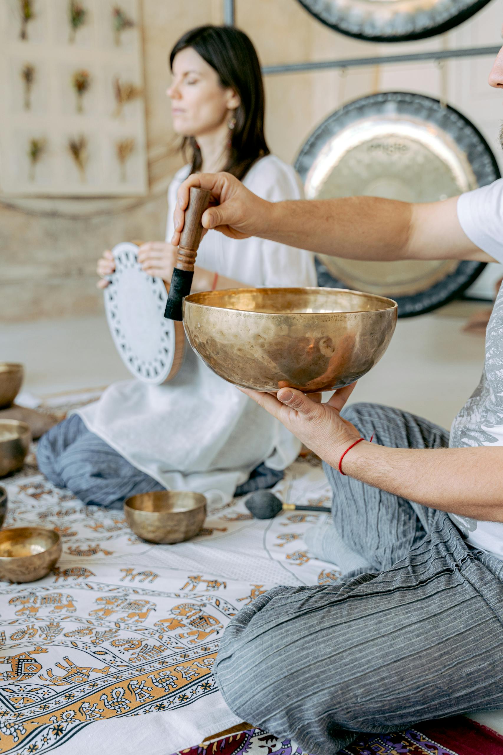 A serene meditation session with Tibetan singing bowls and traditional attire.