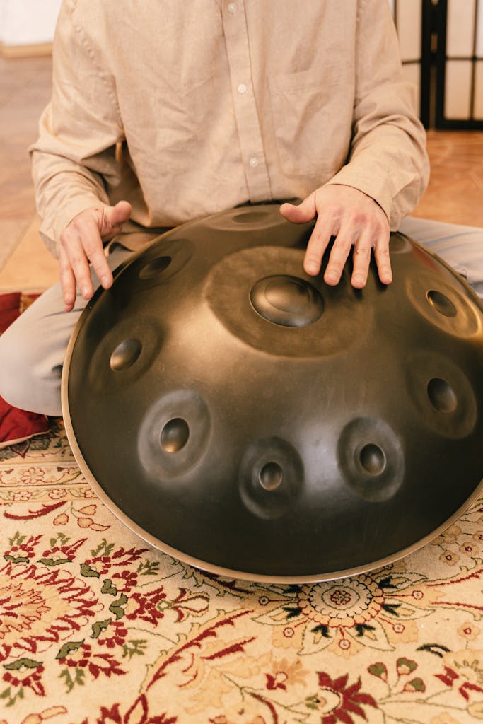 A serene scene featuring hands playing a handpan drum, enhancing relaxation and zen.